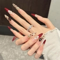 Detailed view of luxury handmade press-on nails with 3D red gems and white flowers. - Red French Stiletto (615) / Large (L)