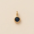 Round golden metal pendant with a dark blue zircon gemstone in a bezel setting - Round September Pendant (Dark Blue)