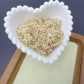 Golden open jump rings for jewelry making displayed in a white heart-shaped ceramic bowl - 0.6*4mm / Rose Gold