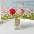 Handmade crochet tulip decor with red and pink flowers in a glass bottle with wood neck - Plump Tulip