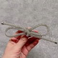 Elegant silver metallic bow hair tie with crystal rhinestones and cylindrical ends - Full Rhinestone Bowknot Hair Clip / Silver