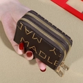 Close-up of a brown leather double zipper coin purse with embossed letters and gold hardware - M-Print Brown