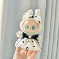 Green plush rabbit doll wearing a white dress with black bow tie for Labubu figures - Camellia Pendant - Bow Skirt / First And Second Generation Keychains Are Compatible With La Cloth Dolls. Dolls Not Included.