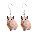Macro shot of cute acrylic hamster earrings with realistic brown and white animal fur patterns - Hamster