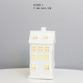 Detailed close-up of a white ceramic house night light with warm LED glowing through windows - RH2282 (7.1x6.2x14.1cm)