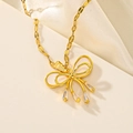 Close-up of golden bow pendant with white enamel and sparkling rhinestones on silk - Enamel Bowknot (F412)