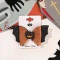 Halloween bat wing hair clip with orange glitter pumpkin face on display card - Pumpkin And Bat Hair Clip