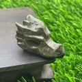Dragon head carving crafted from natural pyrite stone with metallic luster on wood base - Chalcopyrite