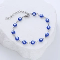 Detail of blue evil eye beads on adjustable stainless steel bracelet with lobster clasp - Blue