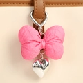 Detail of pink bow keychain with silver heart pendant and metal spring hook on leather strap - Pink