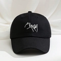 Black cotton baseball cap with white pinky swear embroidery on a neutral fabric background - Black