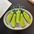 Handmade green pea wool felt keychain set of five displayed on a silver tray - Green Longevity Fruit