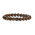 Macro shot of natural Tiger Eye stone beads with a dark grey metal cylinder bead - 8mm Tiger Eye + Bone Bead