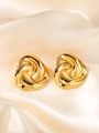 Detail of gold twisted triangle knot earrings on premium champagne satin fabric - Gold Knot Studs