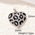 Detailed view of silver heart pendant with leopard enamel pattern and clear gemstone inlay - Silver Black Enamel Leopard Heart