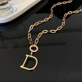 Macro detail of rose gold necklace featuring a black enamel letter D pendant with diamonds - Letter D Style (Rose Gold)