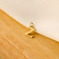 Macro shot of a minimalist gold capital letter Z pendant on a natural wood surface - 14k Letters - Z (letter Height 1cm)