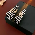 Zebra striped hoop earrings with golden letter B hardware on a dark jewelry box - 26# Black White Striped with Golden Letter B Earrings