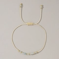Handmade woven cord bracelet with gold beads and light blue natural stone beads - March-Aquamarine