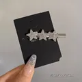 Elegant silver star hair clip with sparkling white rhinestones on display card - Silver Triple Star