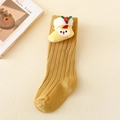 Close-up of ginger yellow knit baby socks with 3D teddy bear and holly christmas decoration - Ginger - Yellow Boot