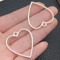 Pair of silver heart-shaped alloy hollow frames for DIY pendant jewelry making - Heart Shape Bezel (22246) / 34x31mm / Bright Silver