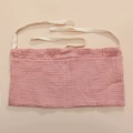 Close-up of pink cotton muslin crib organizer showing textured fabric and dual pockets - Dusty Pink