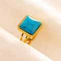 Macro detail of a vintage square turquoise ring with a gold adjustable double-row band - Gold/Dark Blue Turquoise