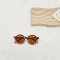 Detail of round leopard print kids sunglasses on white fabric with UV400 CE label - Leopard Orange