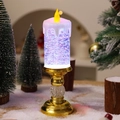 Detalle de vela LED navideña con base dorada y efecto de nieve con purpurina móvil - Degradado Bañado en Oro
