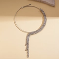 Detail of silver tasseled choker featuring sparkling rhinestones on stone background - Silver