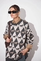 Close-up of knit crewneck sweater featuring argyle patterns and horse motif embroidery - Gray