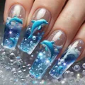 Detail view of 3D dolphin nail charms and water droplet accents on blue press-on nails - Ocean Dolphin 3D Style (AW449)