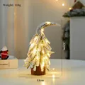 Miniature 22cm snow-covered Christmas tree with warm LED lights and a natural wood base - Snowy Crooked Tree Small with LED Light