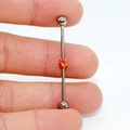 G23 titanium industrial barbell earring with a vibrant orange zircon center stone - Orange Zirconia