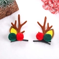 Close-up of brown reindeer antler hair clips with plush pom-poms on white fur background - 1 Pair Red Green Pompoms