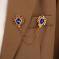 Detail of vintage gold collar pin set with blue water-drop gems on a brown suit jacket - KC Gold Base Royal Blue Water Drop (N-148)