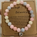 Pink zebra stone bead bracelet with silver heart charm on a kraft gift card - Colored Stone Heart With Card