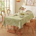 Detail of green cotton linen tablecloth with white floral pattern on a wood table - Green With White Leaf