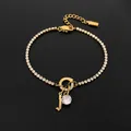 Stainless steel tennis bracelet with 14K gold finish, letter J and crystal pendants - Letter J