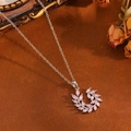 Macro shot of silver leaf pendant with pink marquise zircon and delicate chain - Silver Wreath Leaf Style