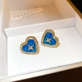 Macro detail of heart-shaped gold and blue enamel earrings with sparkling rhinestones - Blue Enamel Heart Four-Point Star Studs (28#)