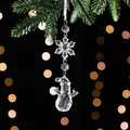 Clear acrylic Christmas snowman and snowflake pendant on green pine branch with bokeh - Snowflake String F