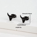 Macro shot of black bull head stud earrings with size specs 1cm by 0.8cm on stone base - 057 Bull Head Black