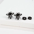 Macro shot of black hollowed-out honey bee stud earrings with matching butterfly backings - 279 Black (Wasp)
