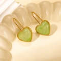 Detail view of light green marble heart earrings with golden stainless steel frames - Green