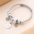Bracciale a cavo in acciaio argentato con ciondoli a farfalla, albero della vita e zirconi - Bianco