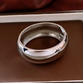 Detailed macro view of silver-tone metal cuff bracelet with polished finish and hinge opening - Silver Wide Mirror Bangle (HB3411)