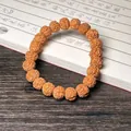 Brown textured Rudraksha seed bracelet with 18 natural round beads on a wooden desk - Premium Rudraksha 8-12mm (Single Loop)