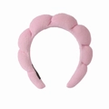 Detailed view of pink towel fabric headband with thick padded twist texture for skincare - Pink Terry Headband